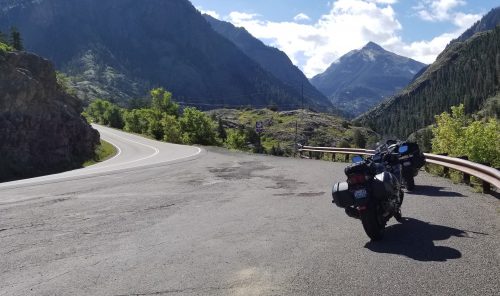 Sport Touring motorcycles riding into a deep wooded canyon on the Million Dollar Highway outside Ouray Colorado  