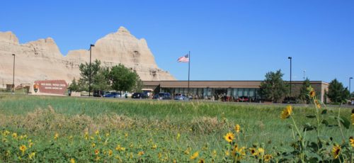 Ben Reifel Visitor Center framed against cliffsides and blue skies in Badlands National Park 