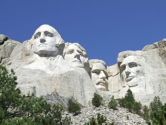 Mount Rushmore against a bright blue sky