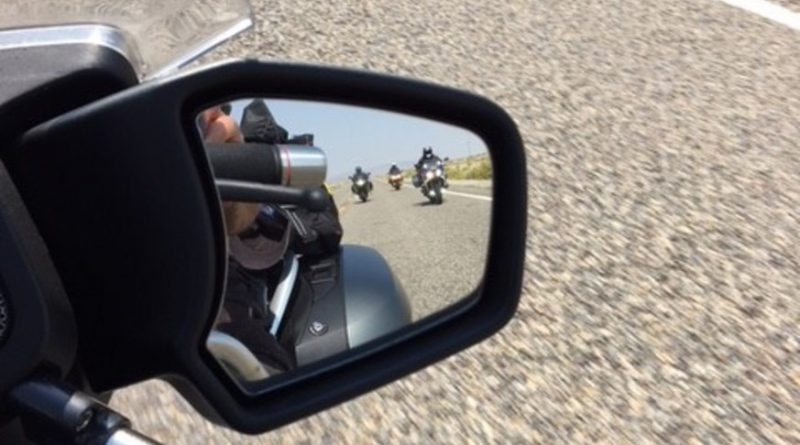 Motorcycle riders approaching in rear-view mirror