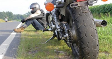 Motorcyclist stranded on roadside.