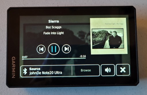 Zumo music app display showing album name, album cover, song title and music player controls