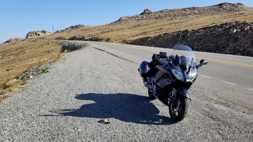 Sport Tourer on a pullout looking up to the summit of Beartooth Pass