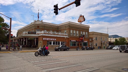 The brown brick two story Irma Hotel building on a corner of main street in Cody WY  