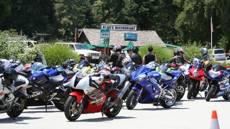 an assortment of colorful sportbikes in front of Alice's Restaurant 