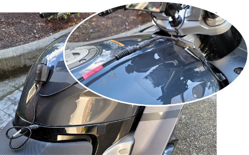 Oval shaped cutout showing heated gear wiring harness on a Yamaha FJR 