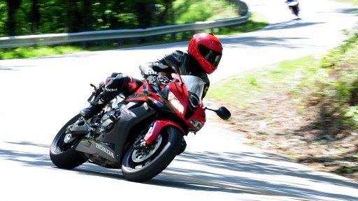 A sport rider leans into a turn on Devil's Whip 