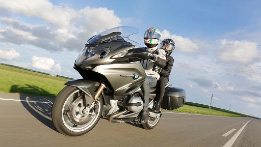 Two-up motorcycle riders on the open road.