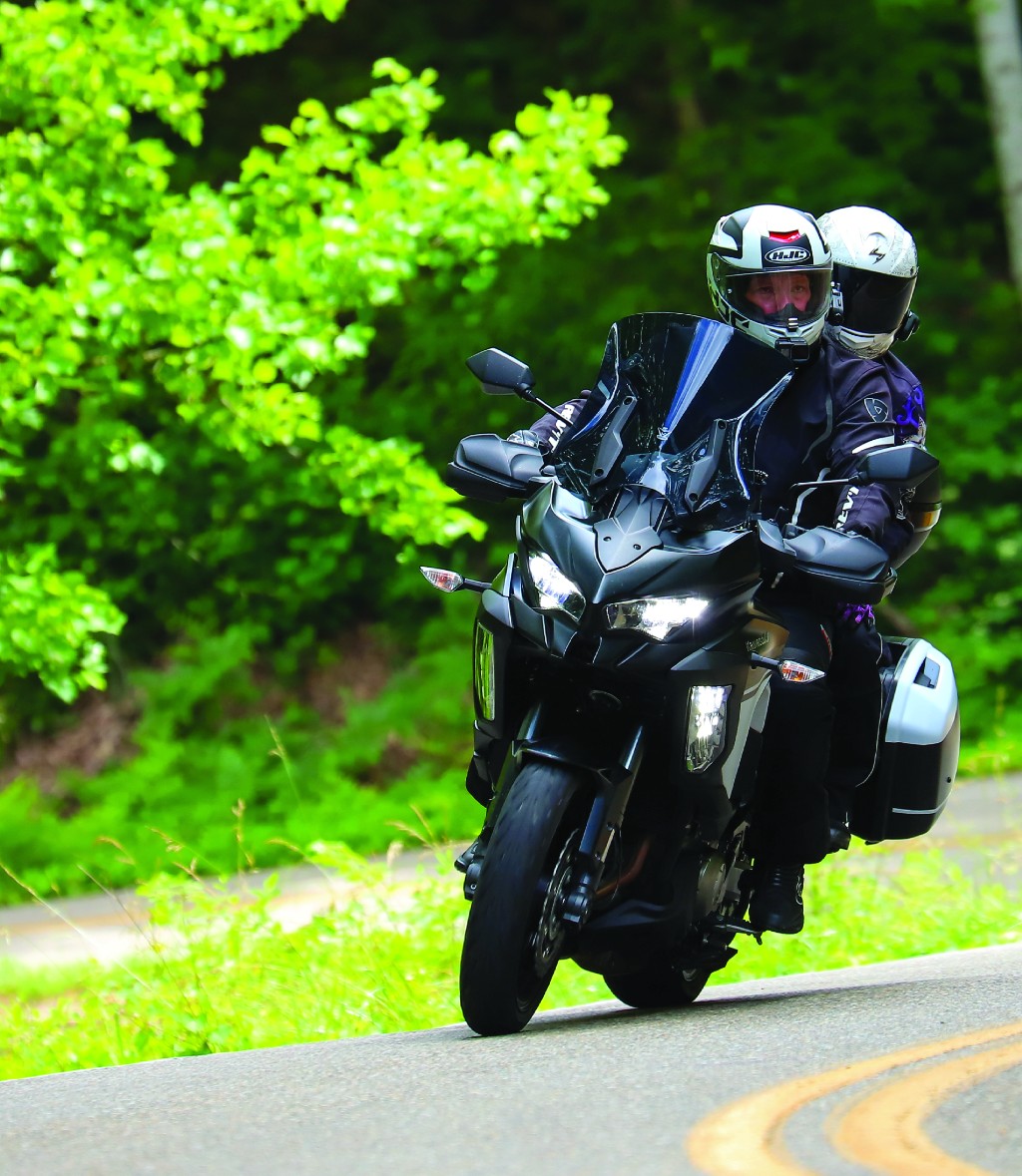 Motorcycle with rider and pillion in twisties