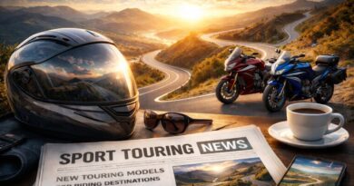 Sport touring motorcycles parked along a winding mountain road at sunset, with riding gear and a newspaper in the foreground.