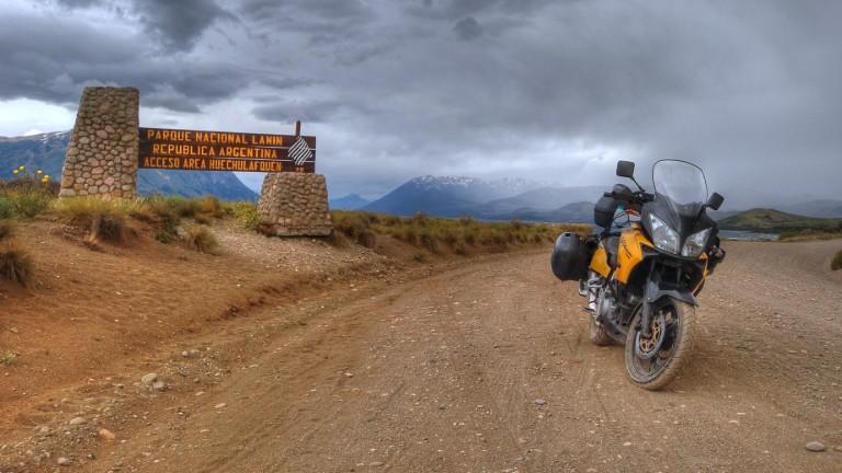 A Suzuki V-Strom parked on a dirt road in Patagonia