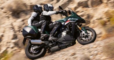 2026 BMW S 1000 XR on the road with rider and passenger.