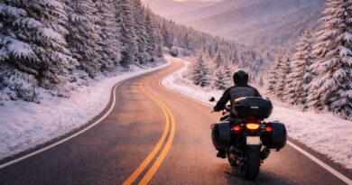 A lone rider on a snowy mountain road.