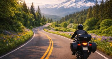 Solo rider approaching mountain on winding road.