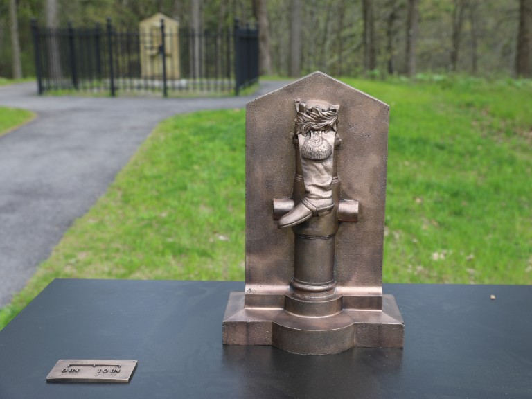 A bronze casting of Saratoga’s Boot Monument recalls Benedict Arnold’s battlefield wound and his decisive role in the American victory.