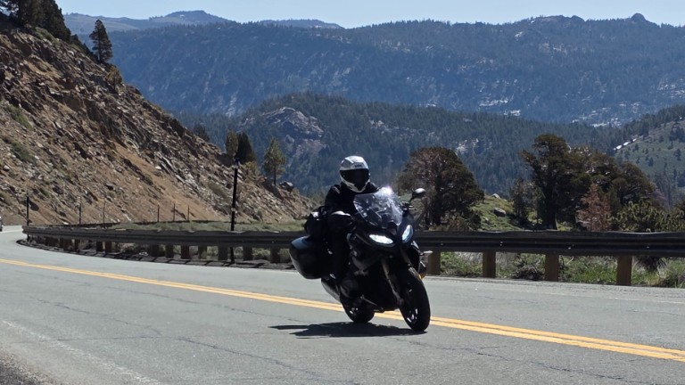 Rider in full gear on mountain road